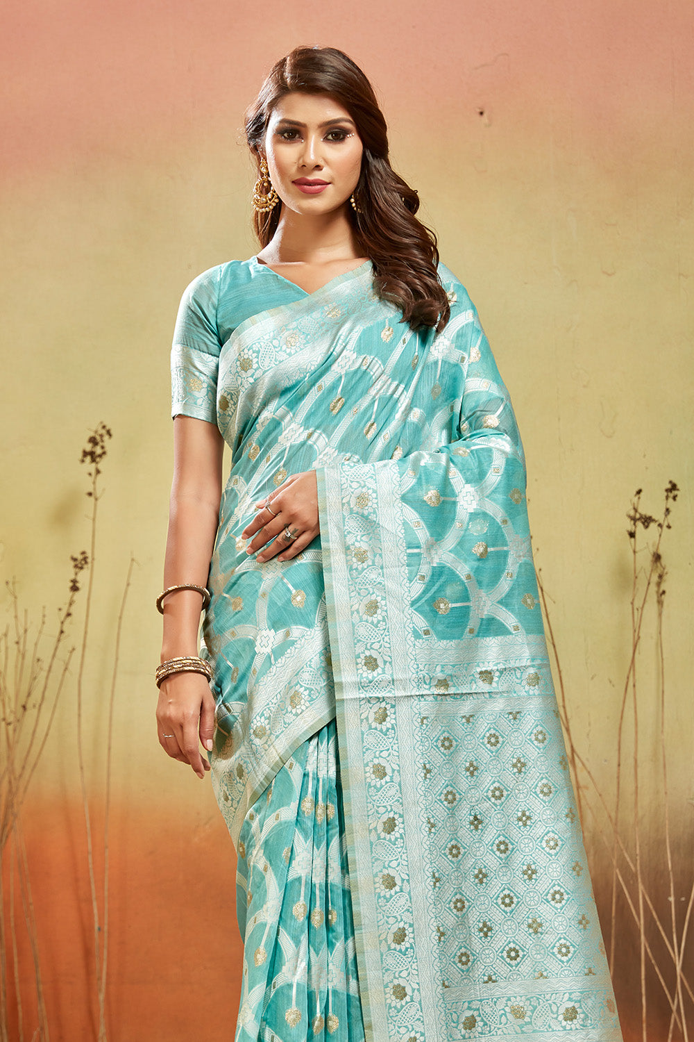 Sea green organza saree with silver zari detail