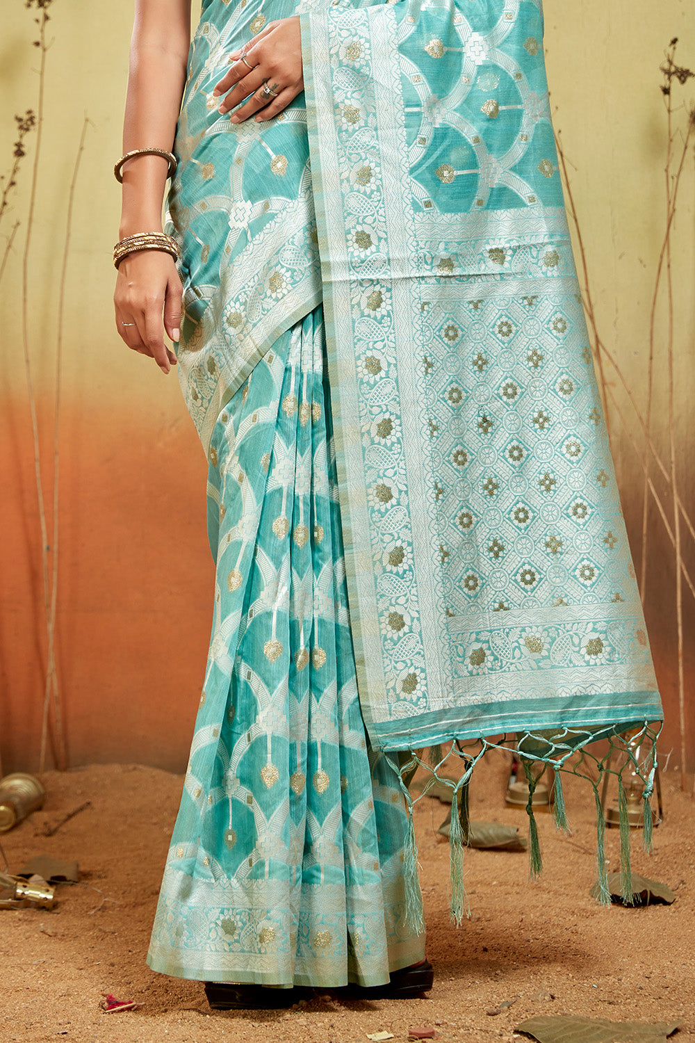 Sea green organza saree with silver zari detail